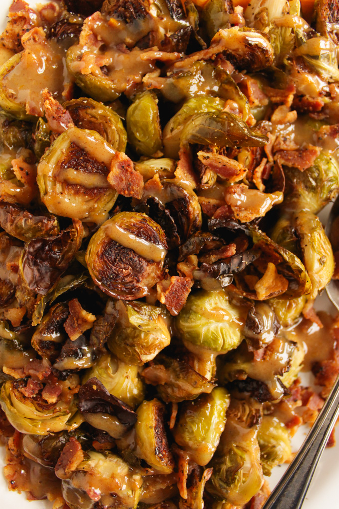 Brussels Sprouts and Bacon with Orange Tahini Sauce has all the flavors, savory, salty, and sweet. It makes the perfect fall or Thanksgiving side dish to any meal. #easyrecipe #bacon #Thanksgiving #brusselspsrouts #glutenfree | robustrecipes.com