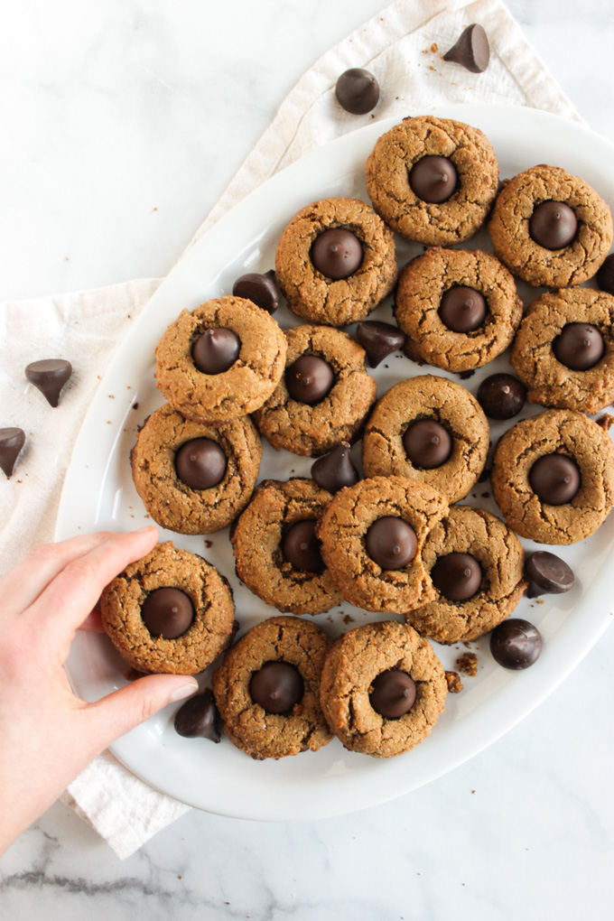  Peanut Butter Blossom Cookies (Gluten Free) - soft and chewy peanut butter cookies with a dark chocolate kiss in the center. They are easy to make and gluten free. Extra special for the Holidays but perfect any time of year. #glutenfree #easyrecipe #recipe #peanutbutter #chocolate #baking | robustrecipes.com