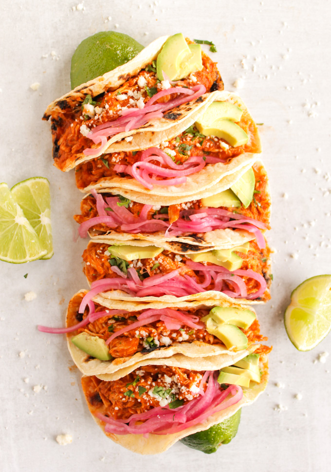 Smoky Instant Pot Chicken Tinga Tacos - chicken tacos coated in a smokey, slightly spicy, tomato sauce and served taco style with pickled red onions, avocado, and cotija cheese.  Easy 30 minute meal. #tacos #chicken #instantpot #mexicanfood #weeknightdinner #easymeal