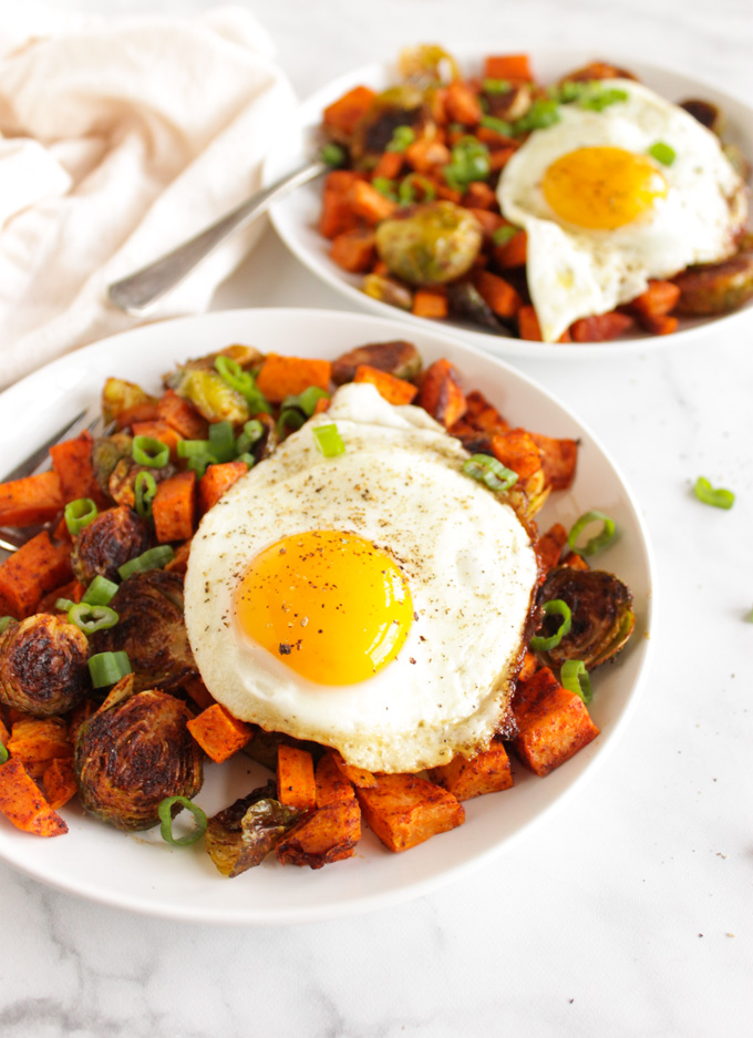 Roasted Sweet potato hash with Brussels sprouts and a fried egg is a healthy and satisfying weekend breakfast that also works great for dinner. Well balanced and nutrition packed this recipe will keep you full until the next meal. #breakfast #sweetpotatoes #healthyrecipe #easyrecipe #weeknightdinner #eggs #glutenfree #vegetarian | robustrecipes.com