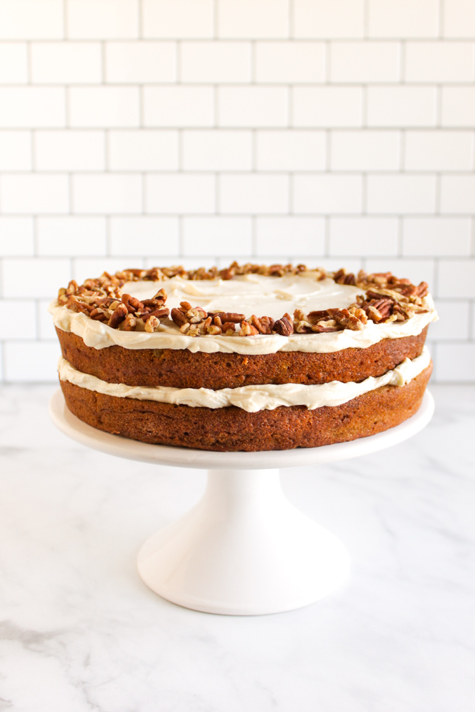Gluten free carrot cake with cream cheese frosting is studded with carrots, raisins, pineapple, and laced with warming spices. The perfect cake for parties and holiday celebrations. #glutenfree #baking #carrotcake #Easter #springbaking #cake #refinedsugarfree | robustrecipes.com