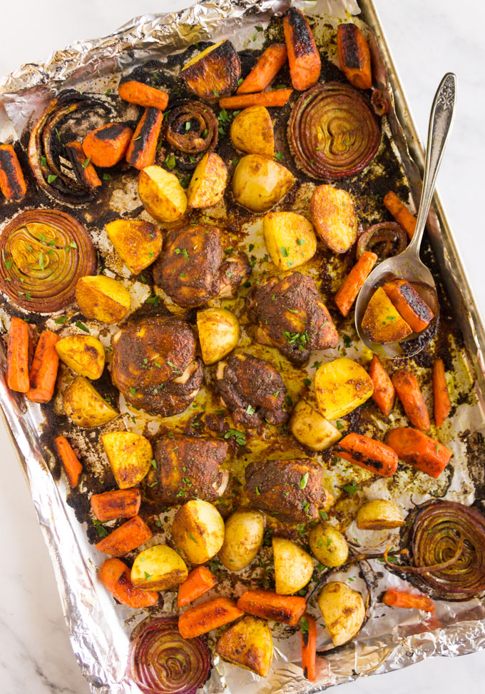 Sheet Pan Moroccan Chicken with Veggies - A one pan meal made in 45 minutes. Exotic, warming spices that will keep your taste buds happy. Easy week night dinner, yet special enough for entertaining. #chicken #easyrecipes #glutenfree #onepandinner #weeknightmeal #carrots #potatoes #healthyfood #cleaneating | robustrecipes.com