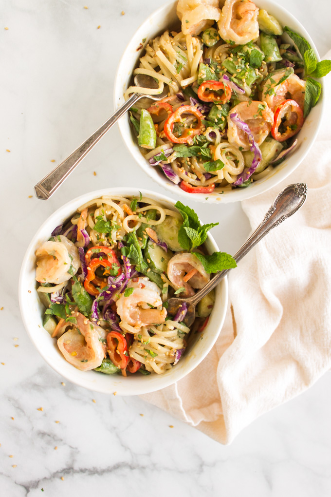 Shrimp Spring Roll Bowls with Tahini Sauce - all the flavors of a traditional spring roll, only with the ease of a bowl. Refreshing, light, and packed with veggies  this meal makes a great weeknight dinner or packed lunch. #recipe #weeknightdinner #springrolls #shrimp #glutenfree #dairyfree #easyrecipe #healthyfood #cucumbers #ricenoodles #seafood #tahini | robustrecipes.com