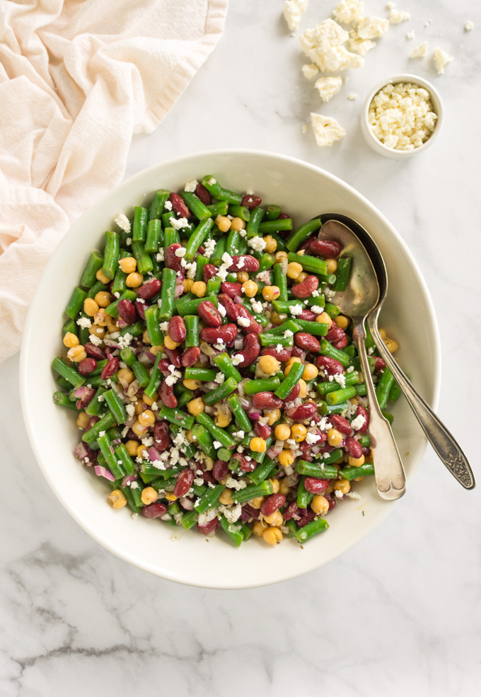 Marinated 3 bean salad - packed with crunchy green beans, and soft kidney beans and chickpeas. The perfect salad to prep for lunches, dinner, or even parties because it is best made in advance with time to marinate, chill, and sort of pickle the green beans. It gets better the longer it sits. #glutenfree #salad #easyrecipe #dairyfree #vegan #vegetarian #sidesalad #greenbeans #fetacheese #chickpeas #garbanzobeans #kidneybeans #healthyfood #cleaningrediens | robustrecipes.com