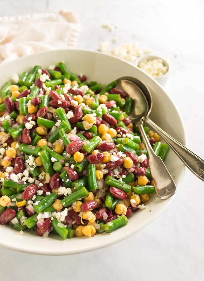 Marinated 3 bean salad - packed with crunchy green beans, and soft kidney beans and chickpeas. The perfect salad to prep for lunches, dinner, or even parties because it is best made in advance with time to marinate, chill, and sort of pickle the green beans. It gets better the longer it sits. #glutenfree #salad #easyrecipe #dairyfree #vegan #vegetarian #sidesalad #greenbeans #fetacheese #chickpeas #garbanzobeans #kidneybeans #healthyfood #cleaningrediens | robustrecipes.com