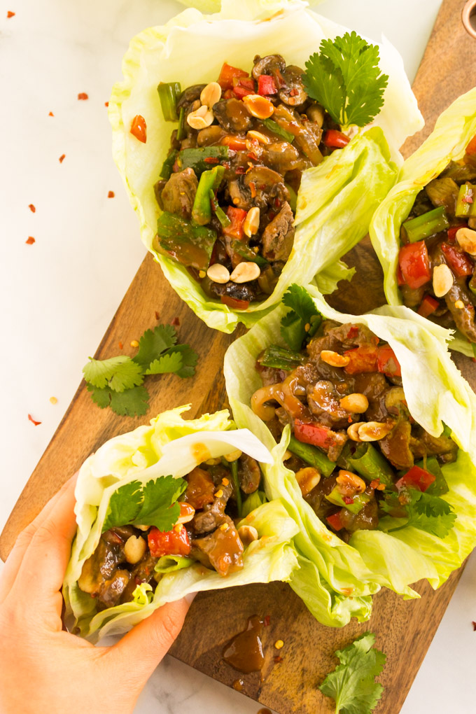 Easy Beef Lettuce Wraps with Peanut Sauce - Asian inspired beef lettuce wraps are the perfect meal for busy weeknights, requires one pan and less than 30 minutes to make. Lite, packed with veggies, and bold flavor these will become a weekly favorite. #glutenfree #dairyfree #easyrecipe #weeknightmeal #onepan #cleaneating #healthy #recipe #beef #peanutbutter #peanutsauce #asianrecipe | robustrecipes.com
