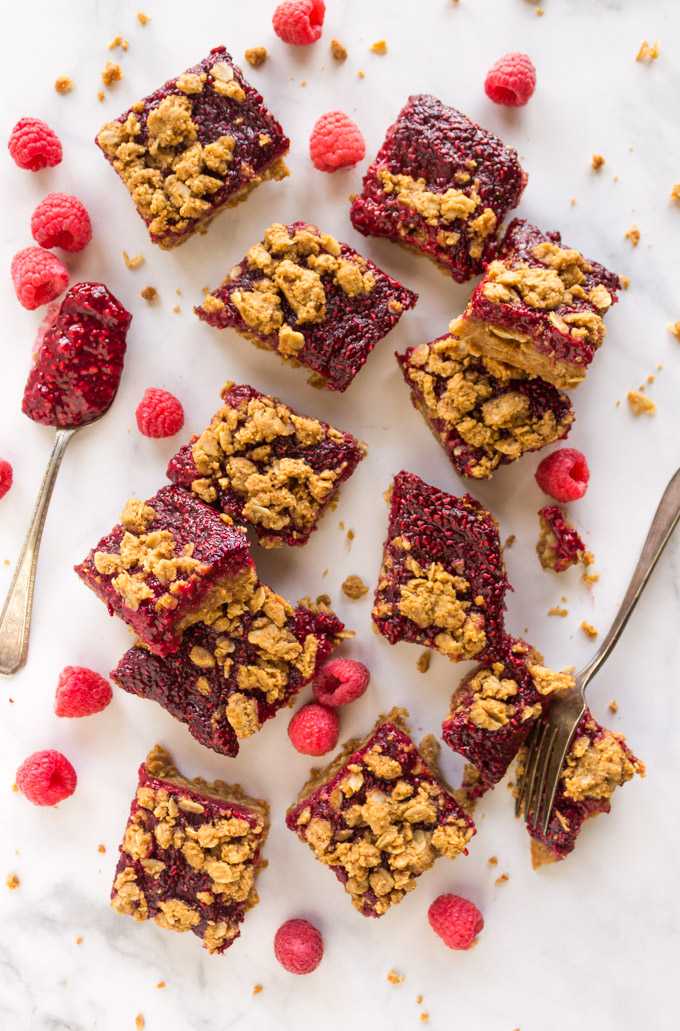 Healthy Peanut Butter Raspberry Bars - a soft, chewy peanut butter crust with a gooey raspberry chia jam baked right on top. Easy to make and healthy, they make the perfect snack or breakfast. #easyrecipe #glutenfree #vegan #glutenfreerecipe #veganrecipe #baking #chia seeds #peanutbutter #raspberries #breakfastrecipe #snack #healthydessert | robustrecipes.com