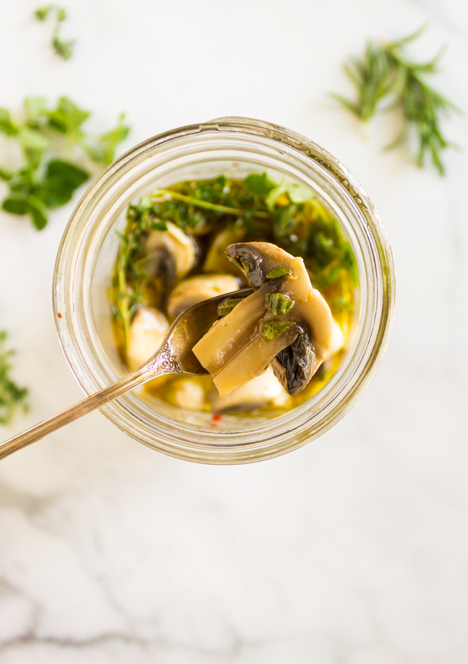 Herbed Marinated Mushrooms - tangy, herby, and delish. They are a great way to add flavor to salads, cheese boards, or as pizza toppings. #easyrecipe #mushrooms #marinated #pickled #herbs #appetizer #condiments #cheeseboard #glutenfree #dairyfree #vegan #vegetarian #healthy | robustrecipes.com
