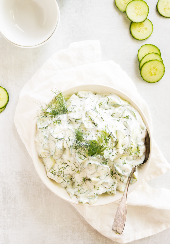 Refreshing Creamy Cucumber Salad - thinly sliced cucumbers with a creamy dill sauce. The perfect side salad for any summertime meal. #easyrecipe #salad #cucumbers #greekyogurt #summerrecipe #glutenfree #vegetarian | robustrecipes.com