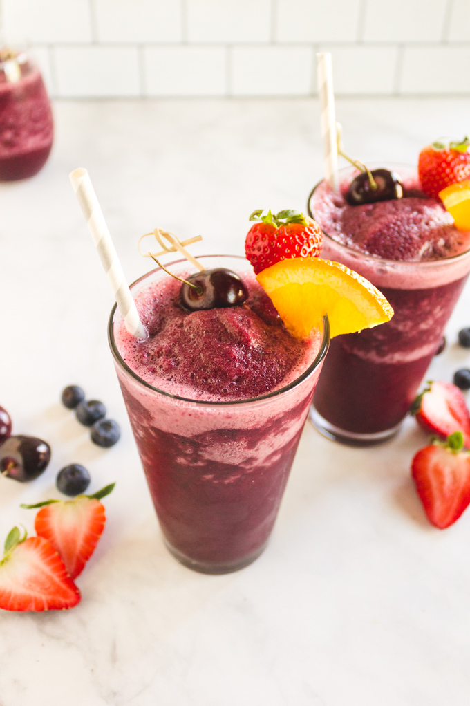 Red Wine Frozen Sangria - a fruity sangria in slushy form. Red wine blended with mixed berries, and orange ice cubes to create the ultimate summertime frozen cocktail. #sangria #redwine #cocktail #summer #frozendrinks #summerrecipes #easyrecipe #vegan #glutenfree #dairyfree #vegetarian #party #refreshing | robustrecipes.com