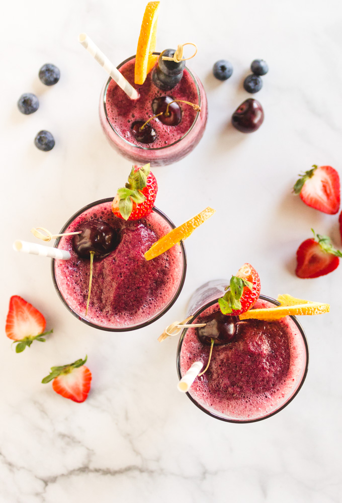 Red Wine Frozen Sangria - a fruity sangria in slushy form. Red wine blended with mixed berries, and orange ice cubes to create the ultimate summertime frozen cocktail. #sangria #redwine #cocktail #summer #frozendrinks #summerrecipes #easyrecipe #vegan #glutenfree #dairyfree #vegetarian #party #refreshing | robustrecipes.com