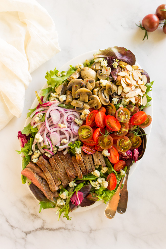Loaded Steak Salad with Creamy Horseradish Dressing - a healthy and filling entree salad topped with homemade creamy horseradish dressing that goes perfect with the steak, tomatoes, and marinated mushrooms. #salad #entree #steak #entreesalad #weeknightdinner #cleanteating #healthy #steaksalad #Greekyogurt #summer #glutenfree | robustrecipes.com
