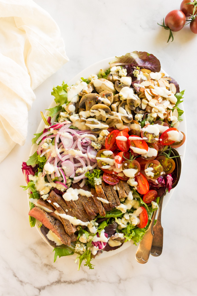 Loaded Steak Salad with Creamy Horseradish Dressing - a healthy and filling entree salad topped with homemade creamy horseradish dressing that goes perfect with the steak, tomatoes, and marinated mushrooms. #salad #entree #steak #entreesalad #weeknightdinner #cleanteating #healthy #steaksalad #Greekyogurt #summer #glutenfree | robustrecipes.com