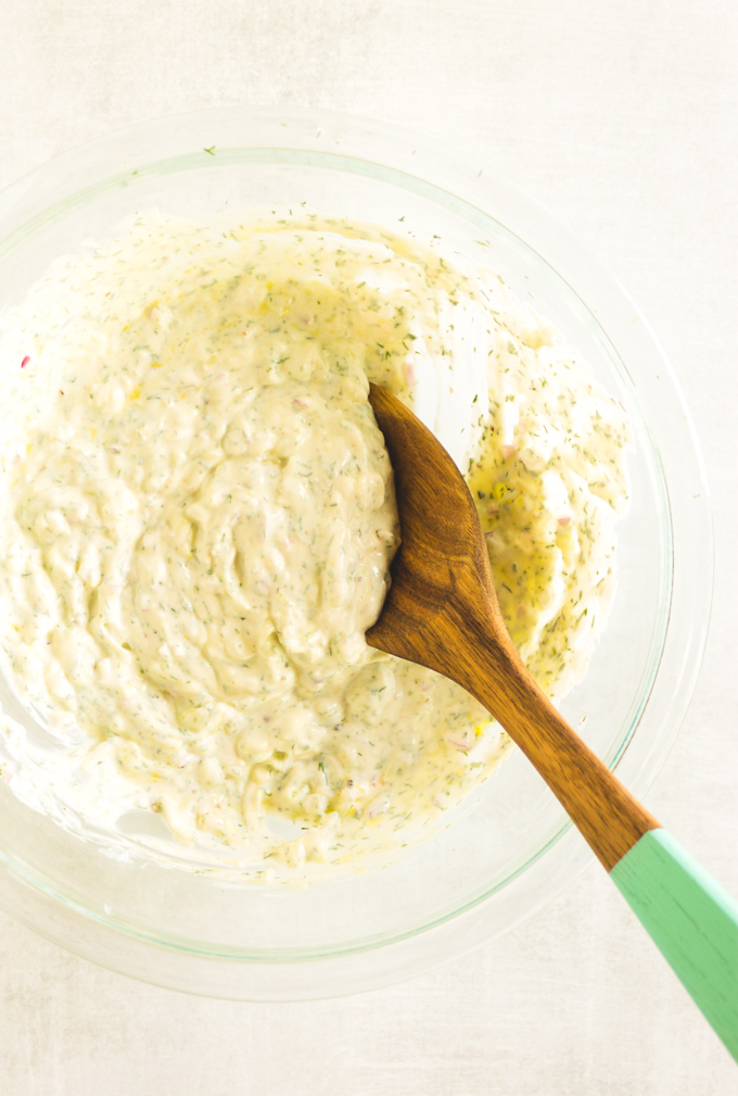 Easy to make Greek Tzatziki sauce that's perfect for dipping veggies, pita chips, or spreading on sandwiches, burgers and gyros. Delicious! #Greekyogurt #dips #appetizer #side #vegetarian #glutenfree #cucumber #greek #easyrecipe | robustrecipes.com