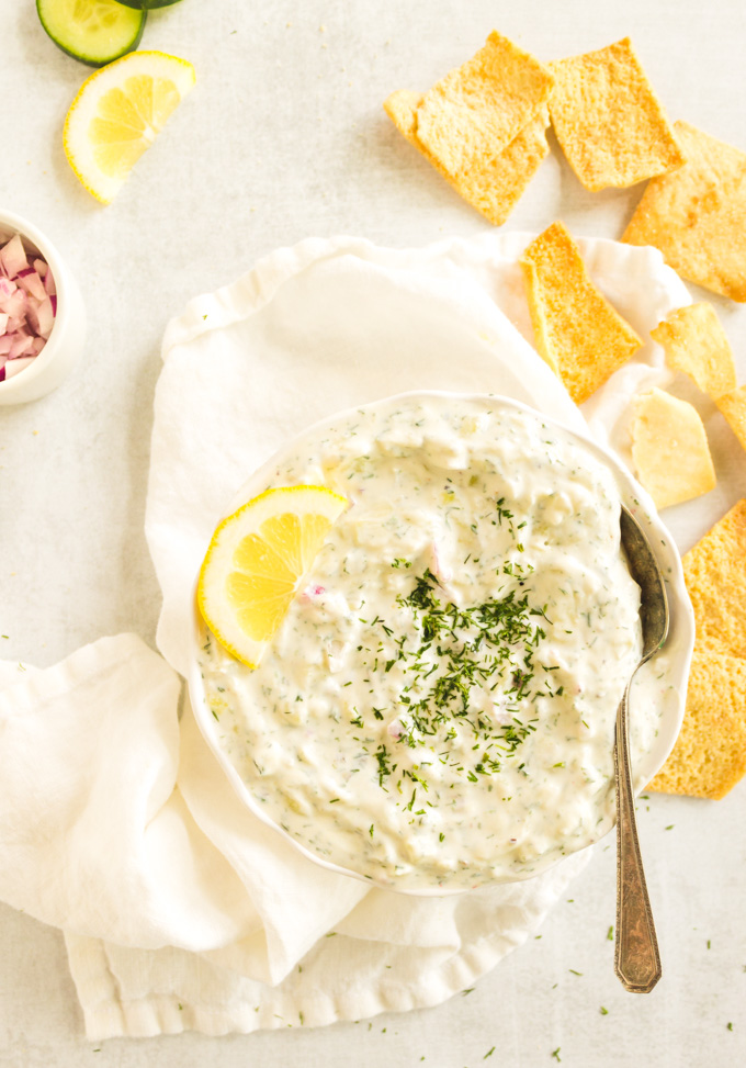 Easy to make Greek Tzatziki sauce that's perfect for dipping veggies, pita chips, or spreading on sandwiches, burgers and gyros. Delicious! #Greekyogurt #dips #appetizer #side #vegetarian #glutenfree #cucumber #greek #easyrecipe | robustrecipes.com