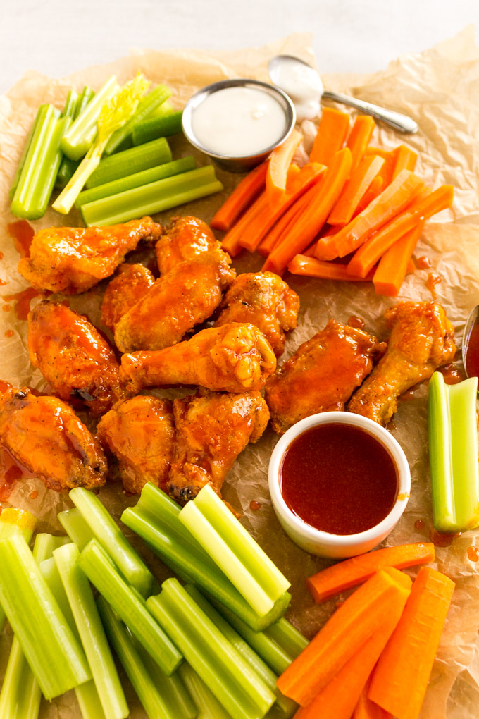 Honey Buffalo Baked Chicken Wings - Restaurant style baked chicken wings are coated in a sticky, sweet, spicy honey buffalo sauce. They are the perfect appetizer for any party, or even served as an entree. #chickenwings #buffalowings #chicken #bakedchickenwings #honey #buffalosuce #easyrecipe #glutenfree #appetizerrecipe #footballrecipe #footballseason | robustrecipes.com