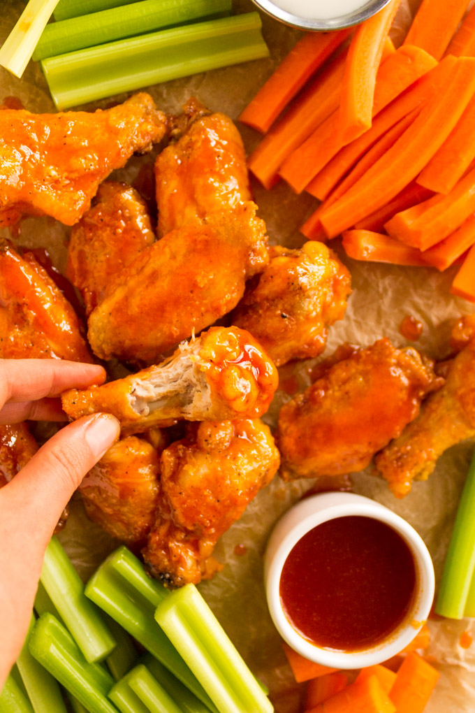 Honey Buffalo Baked Chicken Wings - Restaurant style baked chicken wings are coated in a sticky, sweet, spicy honey buffalo sauce. They are the perfect appetizer for any party, or even served as an entree. #chickenwings #buffalowings #chicken #bakedchickenwings #honey #buffalosuce #easyrecipe #glutenfree #appetizerrecipe #footballrecipe #footballseason | robustrecipes.com
