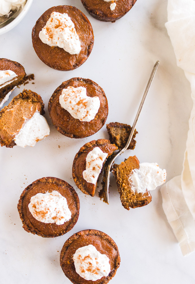 Mini Pumpkin Pies with Ginger Cookie Crust (Bourbon & Maple Infused) - The perfect Thanksgiving or Holiday dessert. Topped with homemade maple bourbon whipped cream they are the ultimate personal-sized dessert. #pumpkinpie #Thanksgivingrecipe #Thanksgiving #pumpkin #pumpkinpiespice #gingerbread #minipumpkinpie #glutenfree #dairyfree #bourbon #Thanksgivingdessert #whippedcream #maplesyrup #dessert #refinedsugarfree | robustrecipes.com