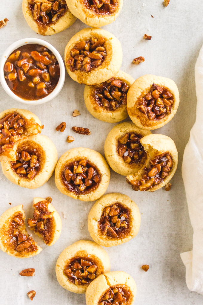 Pecan Pie Cookies (without corn syrup) - Pecan pie cookies are everything good about pecan pie in a cookie form. Soft, buttery cookie with a gooey, maple sweetened pecan pie center. #glutenfree #glutenfreebaking #maplesyrup #pecans #pecanpie #almondflour #cookies #baking #Thanksgivingrecipe #christmas #christmasbaking #christmascookies #dessert #butter | robustrecipes.com
