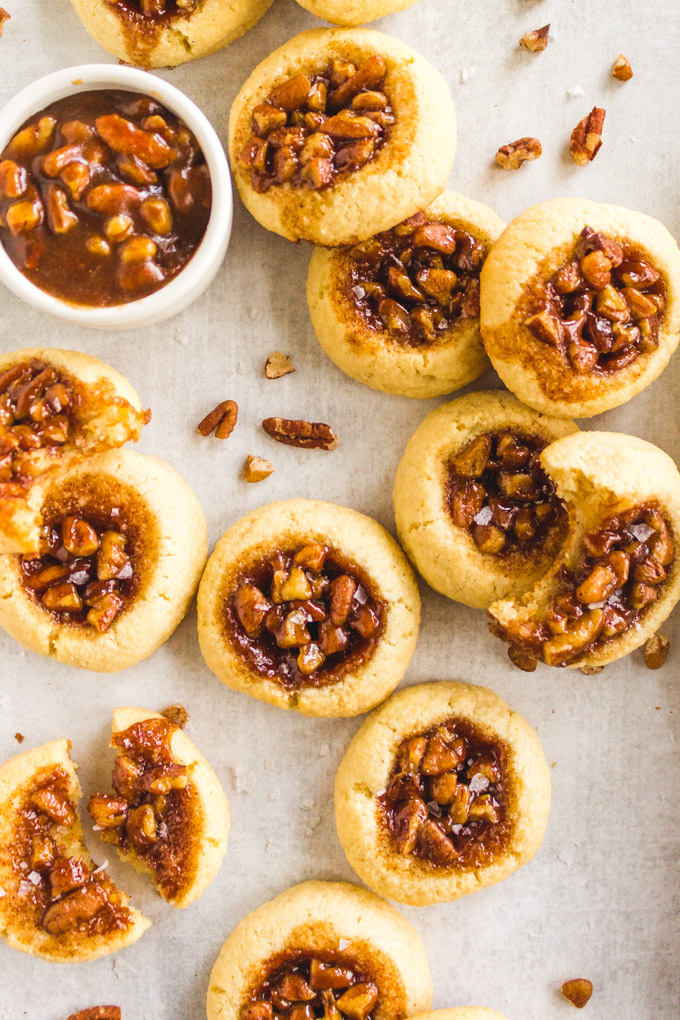 Pecan Pie Cookies (without corn syrup) - Pecan pie cookies are everything good about pecan pie in a cookie form. Soft, buttery cookie with a gooey, maple sweetened pecan pie center. #glutenfree #glutenfreebaking #maplesyrup #pecans #pecanpie #almondflour #cookies #baking #Thanksgivingrecipe #christmas #christmasbaking #christmascookies #dessert #butter | robustrecipes.com