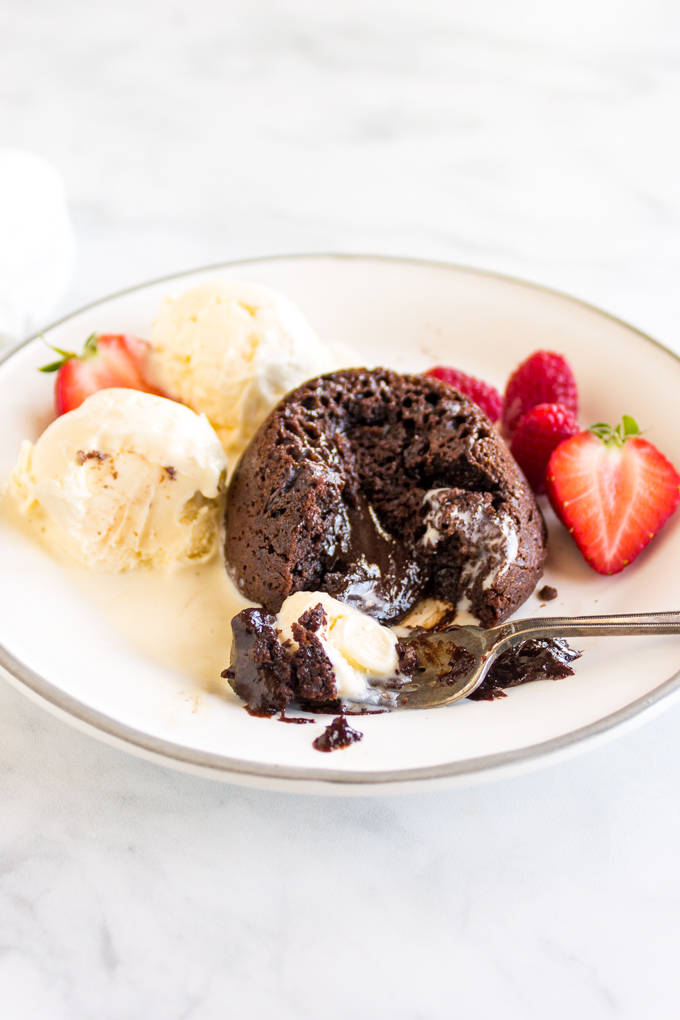 Chocolate lava cake is served warm with a gooey chocolate center. Serve the cakes with vanilla ice cream for the ultimate indulgent dessert that is perfect for Valentine's Day or any other celebration. Gluten free adaptable. #chocolatecake #glutenfreebaking #glutenfree #valentinesdayrecipe #chocolatedesert #glutenfreedessert | robustrecipes.com