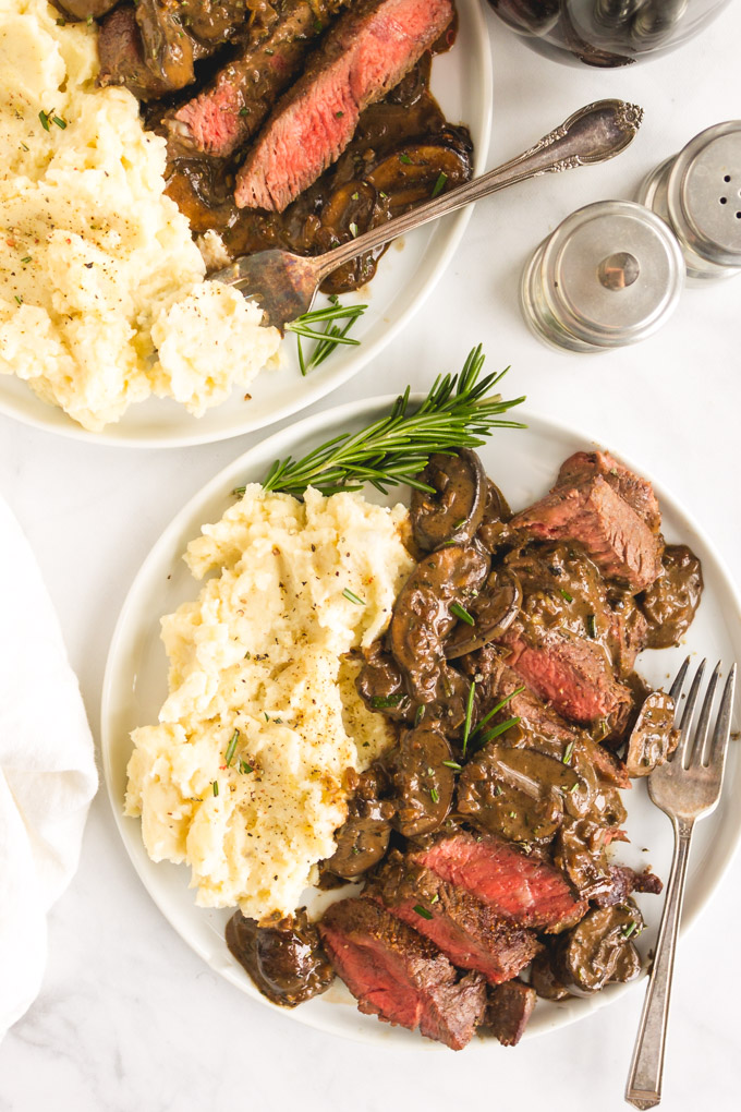 Steak with mushroom sauce is perfect for any date night in.  Juicy steak cooked to perfection served with a creamy mushroom wine sauce. 30 minutes, 1 pan. #steakdinner #steakandmushrooms #30minutedinner #1pandinner #easymeal #datenightrecipe #glutenfreerecipe | robustrecipes.com