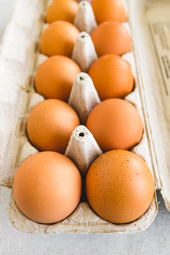 closeup of brown eggs in an egg carton.