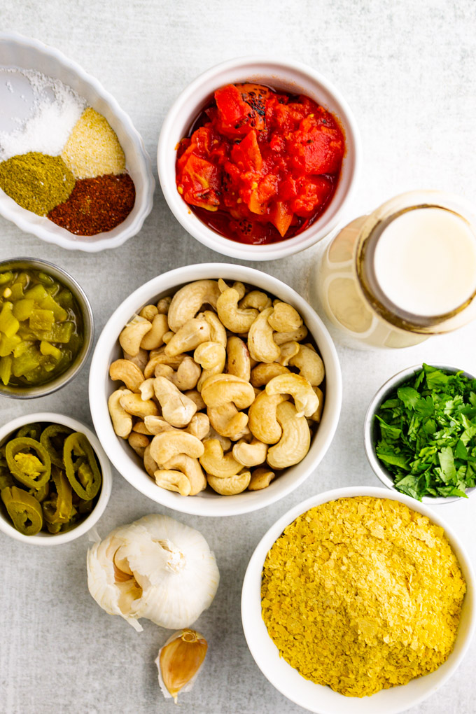 ingredients for cashew queso in white bowls