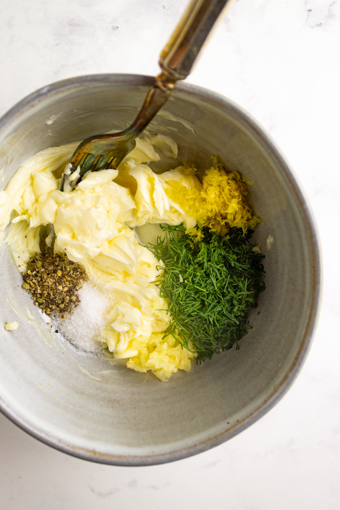 butter, dill, lemon zest, being mixed together in a bowl