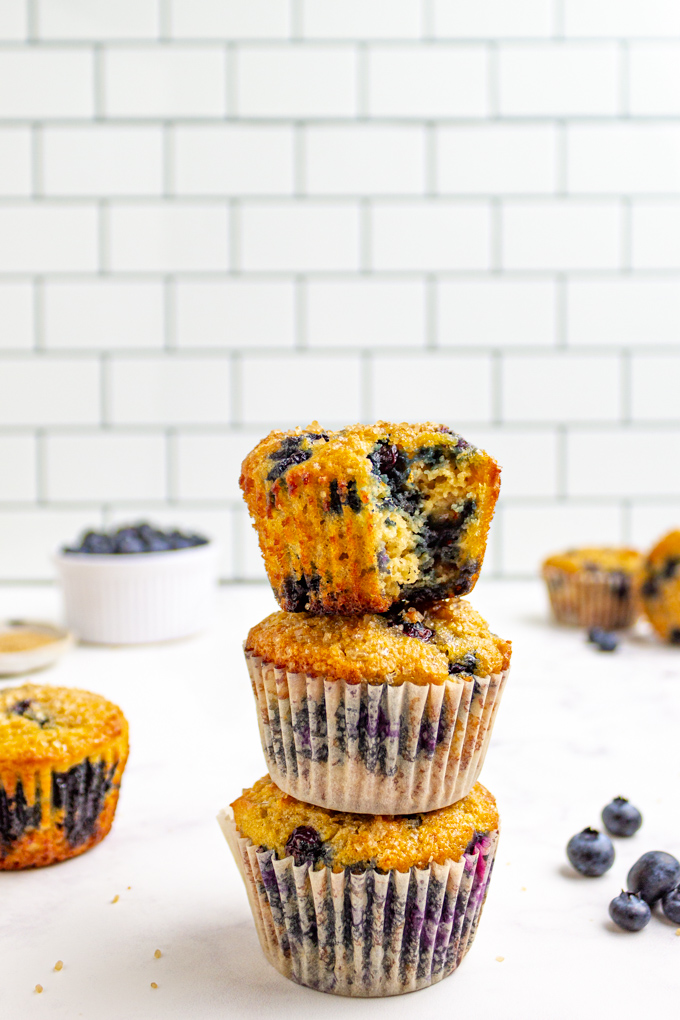 a stack of gluten free blueberry muffins on a white background.