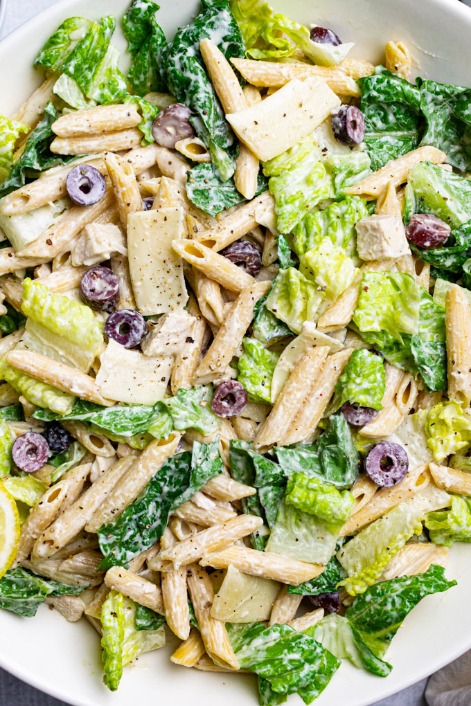 Closeup overhead shot of Caesar pasta salad with chicken.