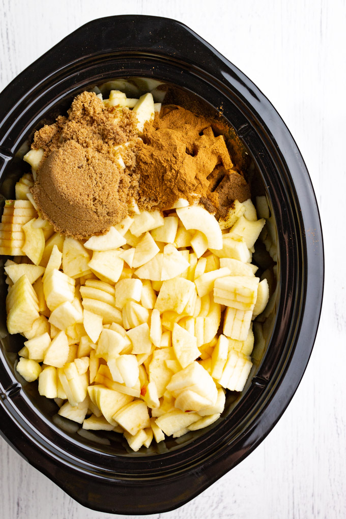 chopped apples, sugar, and spices in a slow cooker.