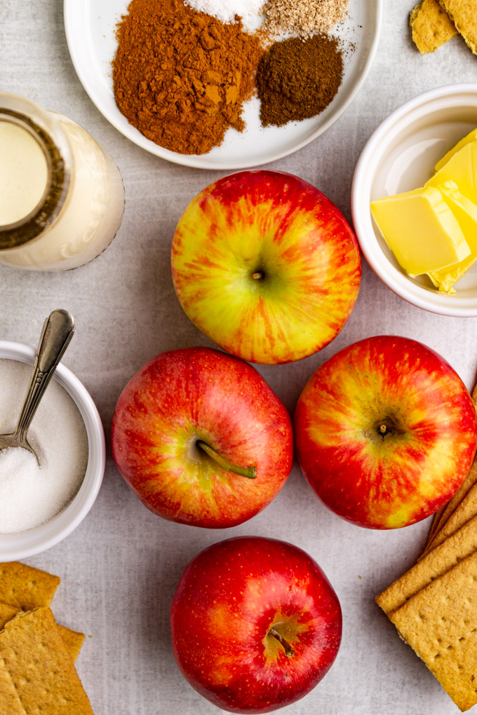 Ingredients in bowls: apples, butter, spices, cream. sugar, graham crackers