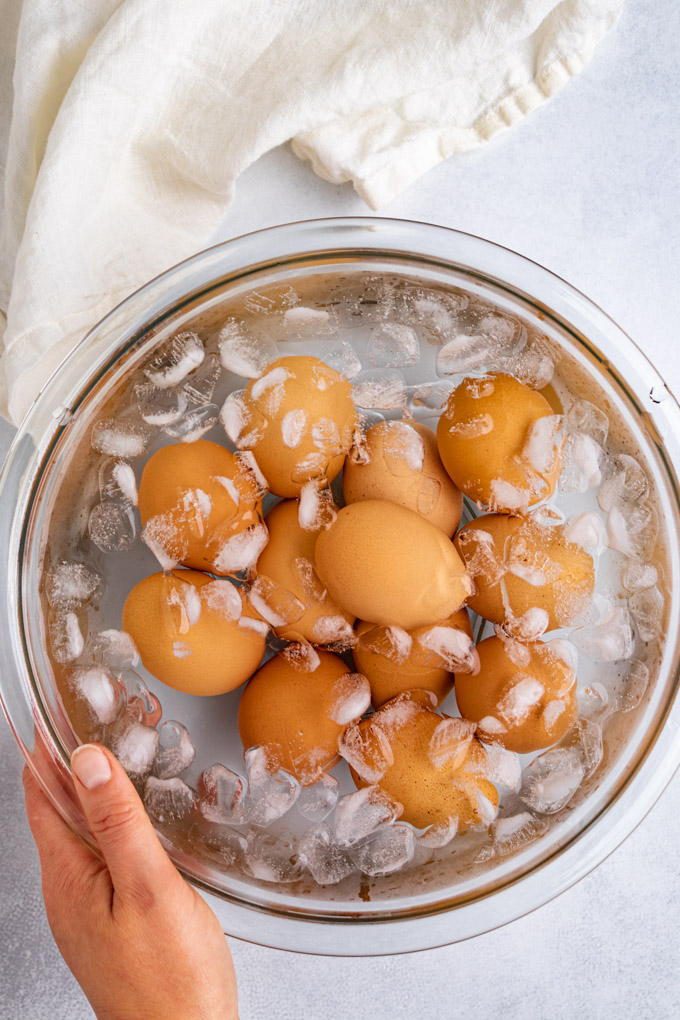 eggs in a mixing bowl with water, and ice for a water bath.