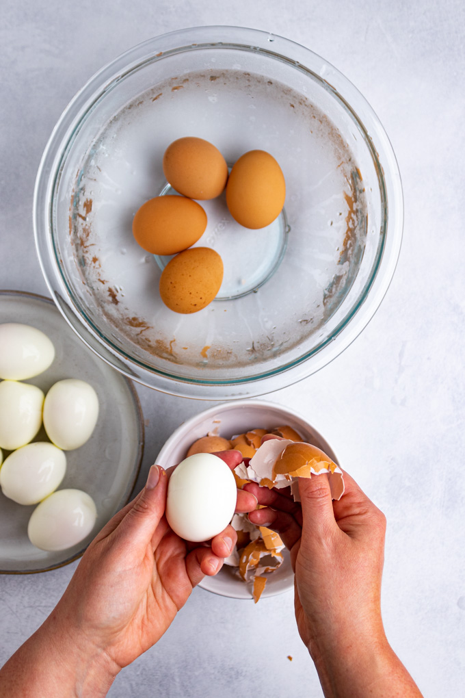 Instant pot hard boiled eggs - eggs being peeled.