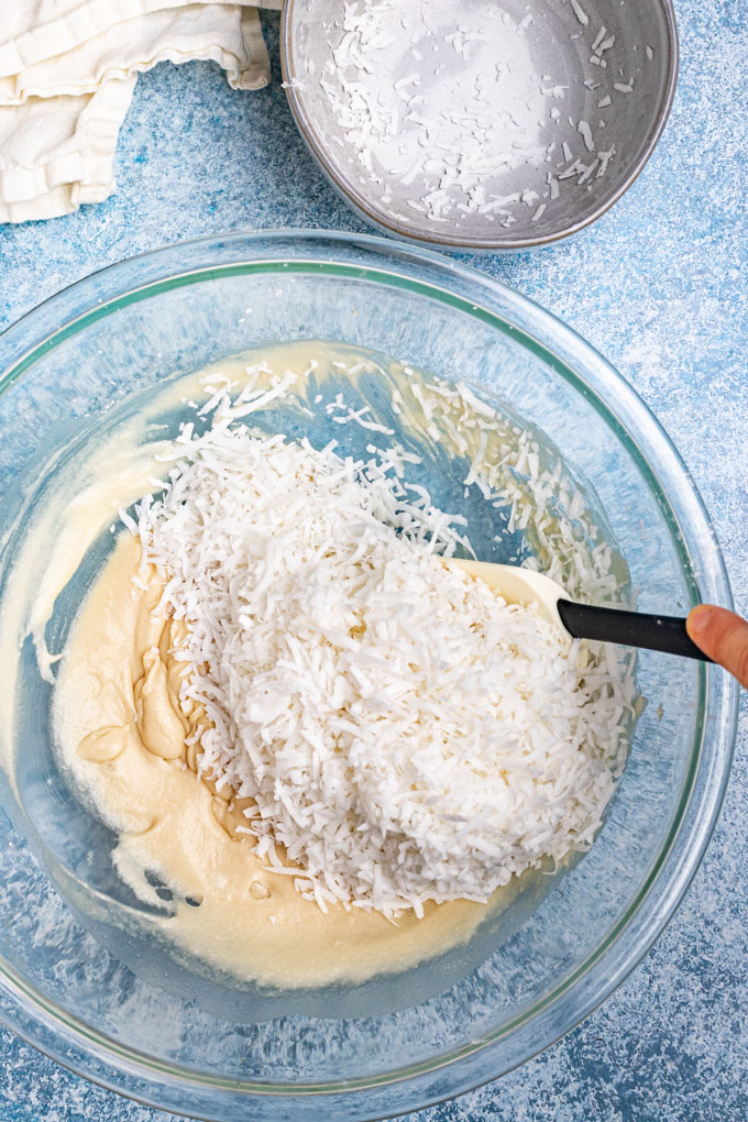 Shredded coconut added to honey and coconut cream mixture.