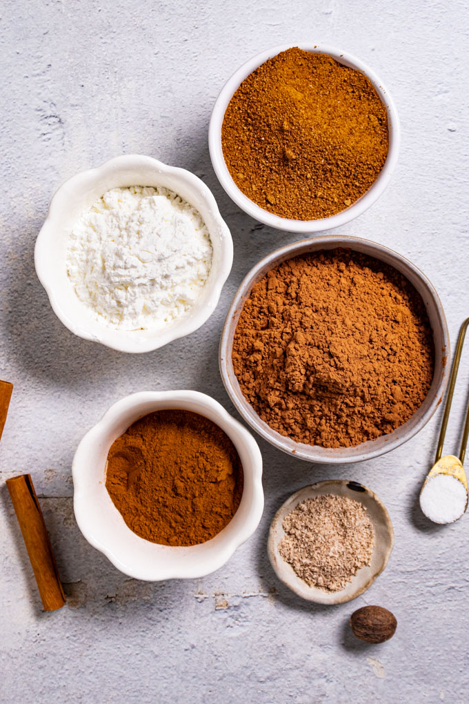 Ingredients are in bowls: cocoa powder, coconut sugar, cornstarch, cinnamon, nutmeg, and kosher salt.