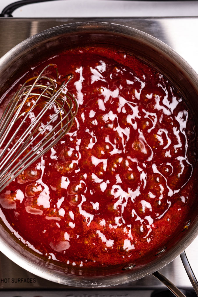 Sweet and sour sauce simmering in a sauce pot.