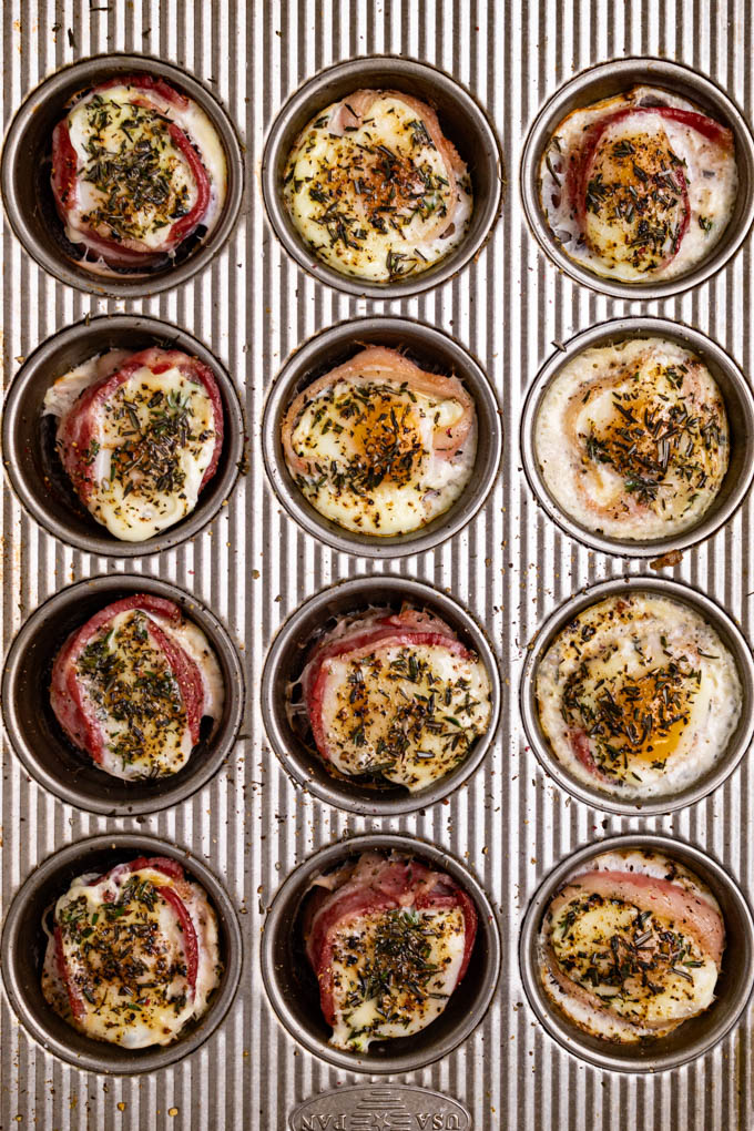 Baked egg cups with bacon in a muffin tin.