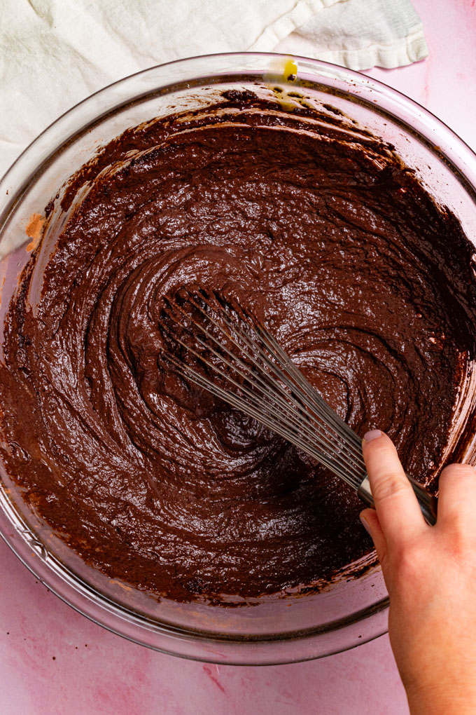 Overhead shot of flourless chocolate cake batter being whisked up.