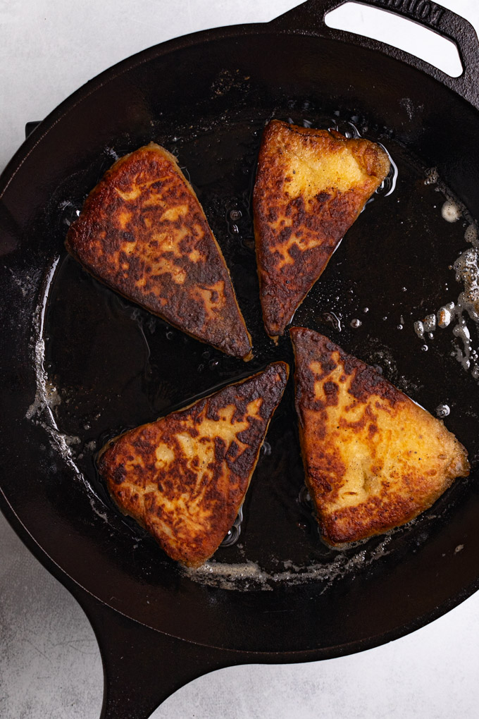 Overhead photo of potato farls cooked in a cast iron skillet.